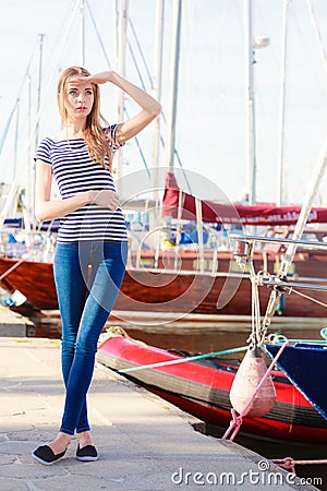 Woman in marina against yachts in port Stock Photo