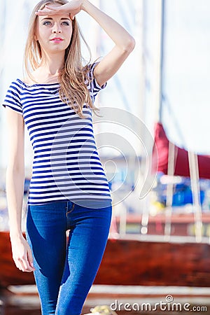 Woman in marina against yachts in port Stock Photo