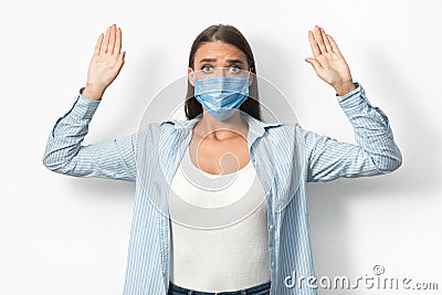 Woman In Mask Raising Hands Breaking Self-Quarantine Rules, White Background Stock Photo