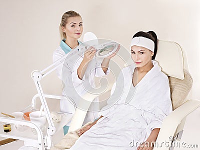 Woman on massage table in beauty spa. Stock Photo