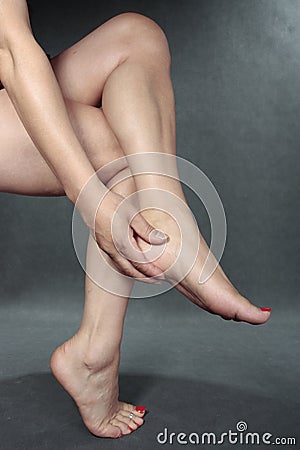 Woman massaging aching feet Stock Photo