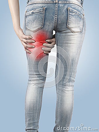 Woman massaging her Hamstrings - Anatomy Muscles. Stock Photo