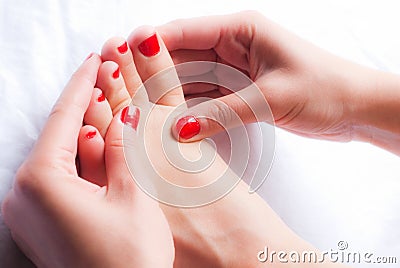 Woman massaging her leg Stock Photo