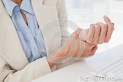 Woman massaging her sore wrist Stock Photo