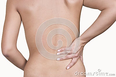 Woman massaging lower pain back Stock Photo