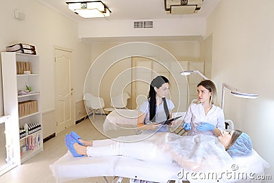 Woman master of microblading teaches female student how to work Stock Photo