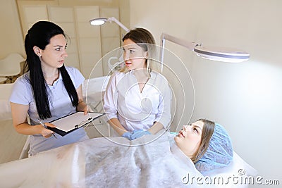 Woman master of microblading teaches female student how to work Stock Photo