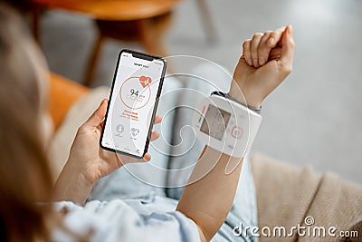 Woman measure heart rate and pressure with smart technology Stock Photo