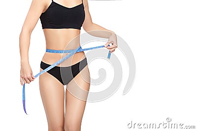 Woman measuring her waist by blue measure tape Stock Photo