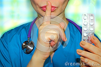 Woman medicine doctor, index finger near the lips, please do not Stock Photo