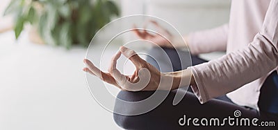 Woman meditating at home. Girl practicing yoga in yoga class panoramic banner. Young girl doing exercises at home. Stock Photo
