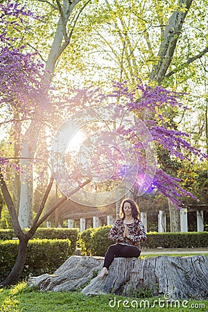 Woman meditating in a park Stock Photo