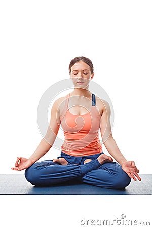 Woman meditating in yoga asana Padmasana Lotus pose Stock Photo