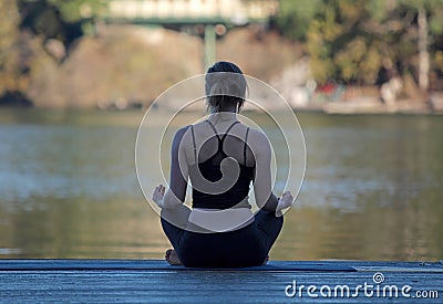 Woman meditating in yoga pose by Cultus Lake British Columbia Stock Photo