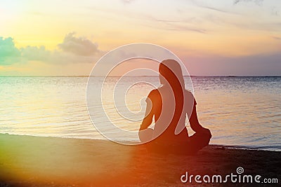 Woman meditation on the beach Stock Photo