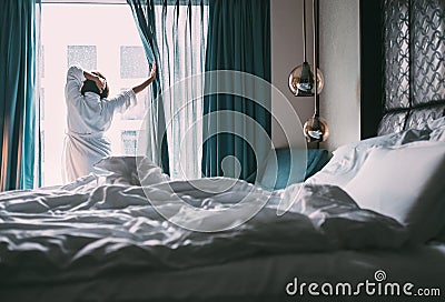 Woman meets rainy morning in luxus hotel room Stock Photo