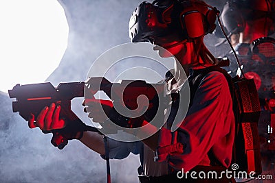 Female mafia member aiming gun at virtual enemy while wearing modern glasses Stock Photo