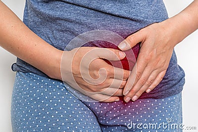 Woman with menstrual pain is holding her aching belly Stock Photo