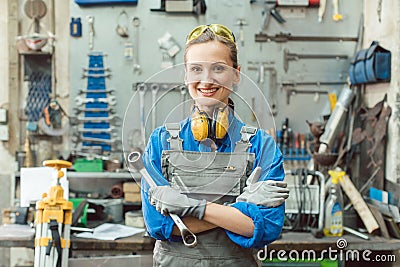 Woman metalworker with tool posing for the camera Stock Photo