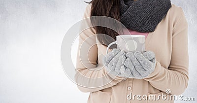 Woman mid section holding polka dot mug against white wall Stock Photo