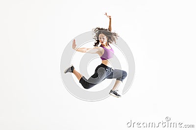 Woman In Midair Practicing Ballet Moves Against White Background Stock Photo