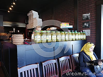 Woman at a Middle Eastern Restaurant Editorial Stock Photo