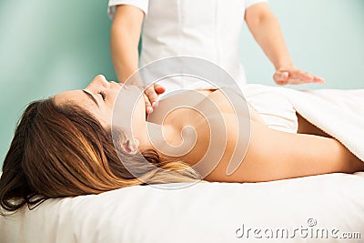 Woman in the middle of a reiki therapy session Stock Photo