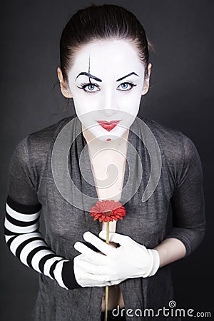Woman mime with red flower Stock Photo