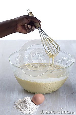 Woman mixing cake ingredients in a mixing bowl Stock Photo