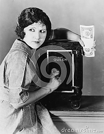 Woman with money and safe Stock Photo