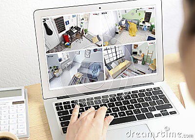 Woman monitoring CCTV cameras at table, closeup. Smart home security system Stock Photo