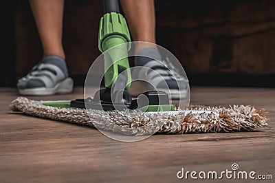 Woman with mop mopping wooden laminate floor Stock Photo