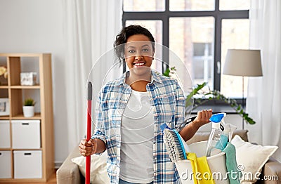 Woman with mop and other cleaning stuff at home Stock Photo