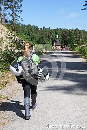 Woman motorcyclist traveler coming to attraction and making picture with her smartphone Stock Photo