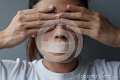 Woman with mouth sealed in adhesive tape. Free of speech, freedom of press, Human rights, Protest dictatorship, democracy, liberty Stock Photo