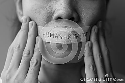 Woman with mouth sealed in adhesive tape with Human rights message. Free of speech, freedom of press, Protest dictatorship, Stock Photo