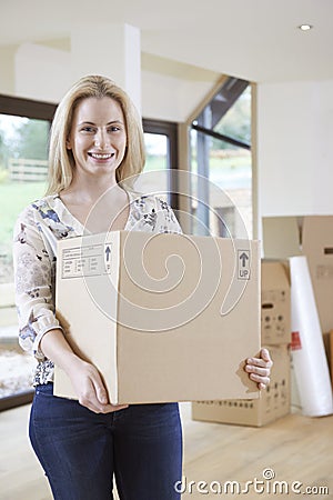 Woman Moving Into New Home With Packing Box Stock Photo