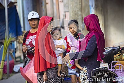 woman Muslim with chidren at the market, village Toyopakeh, Nusa Penida June 22. 2015 Editorial Stock Photo