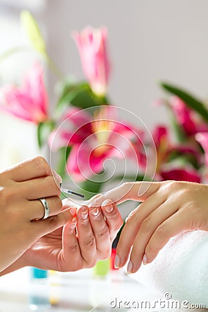 Woman in nail salon receiving manicure Stock Photo