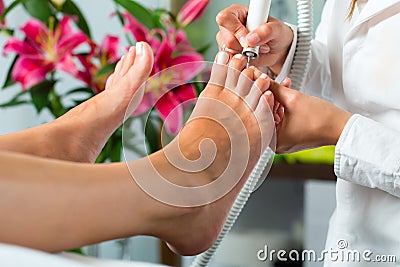 Woman in nail studio receiving pedicure Stock Photo