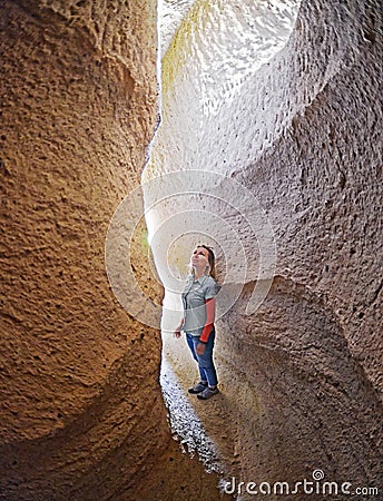 Woman with natural lighting at the caves of red valley Stock Photo