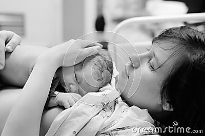 Woman with newborn baby right after delivery Stock Photo