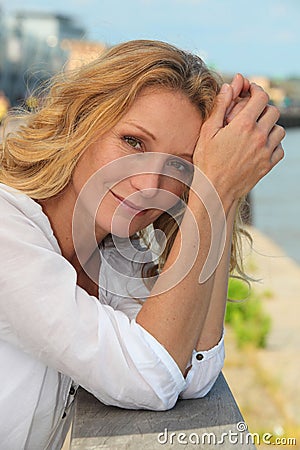 Woman next to a city river Stock Photo