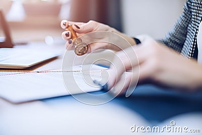 Woman notary public or judge stamping and authorizing document Stock Photo