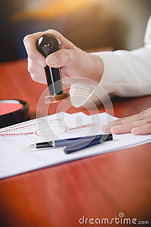 Woman Notary Public stamping the document Stock Photo