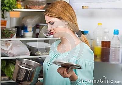 Woman noticed foul smell of food from casserole Stock Photo