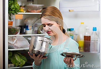 Woman noticed foul smell of food from casserole Stock Photo