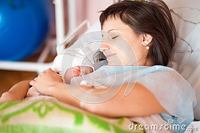 A woman nurses a newborn baby Stock Photo