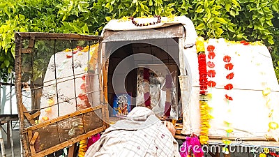 A Woman Obeisance Front To The Photo Of The Lord Shri Radha Krishan. Editorial Stock Photo