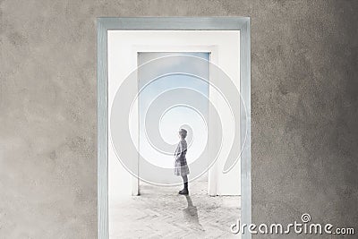 Woman observe curious the door that opens towards freedom and dreams Stock Photo